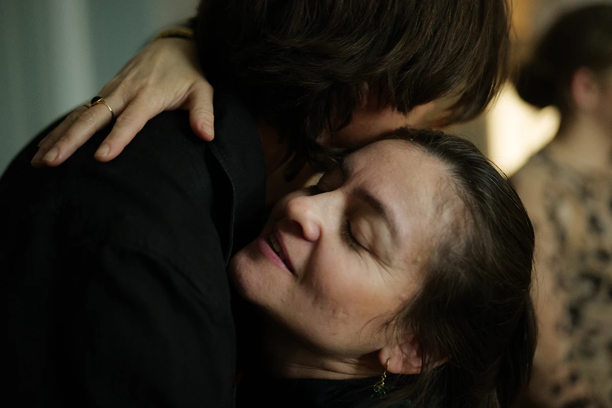 Woman hughs a friend