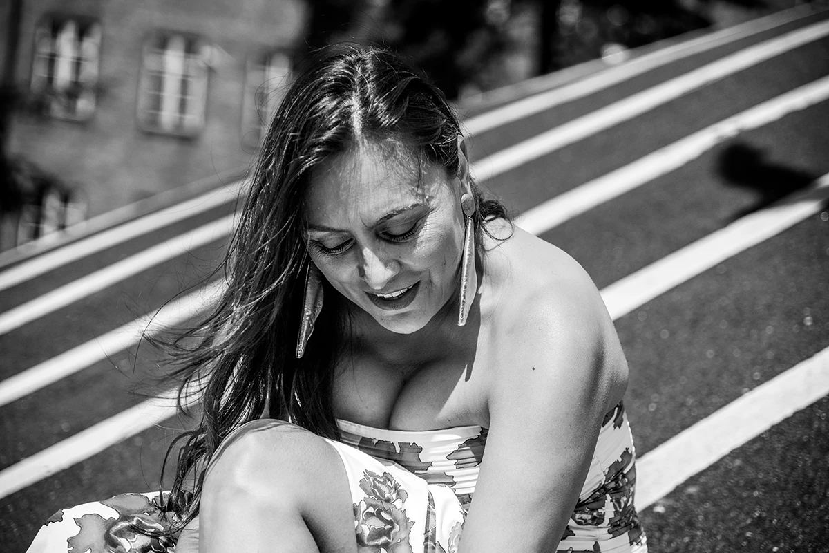 Fashionable woman on the hill at Den Sorte Plads, Copenhagen, with the classic white stripes at the background.