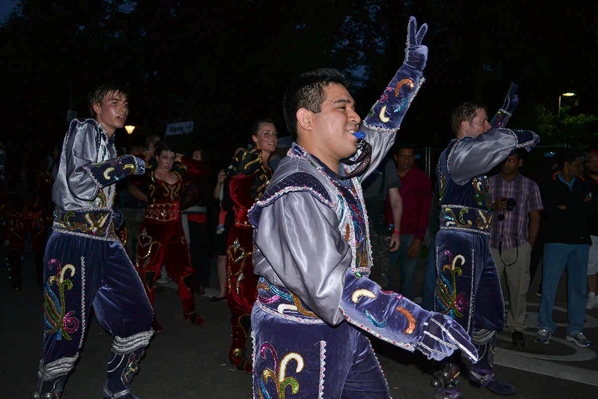 The leader of a Bolivian folkloric dance group gives instructions to his dancers with a whistle at the final parade in the Copenhagen Carnival.