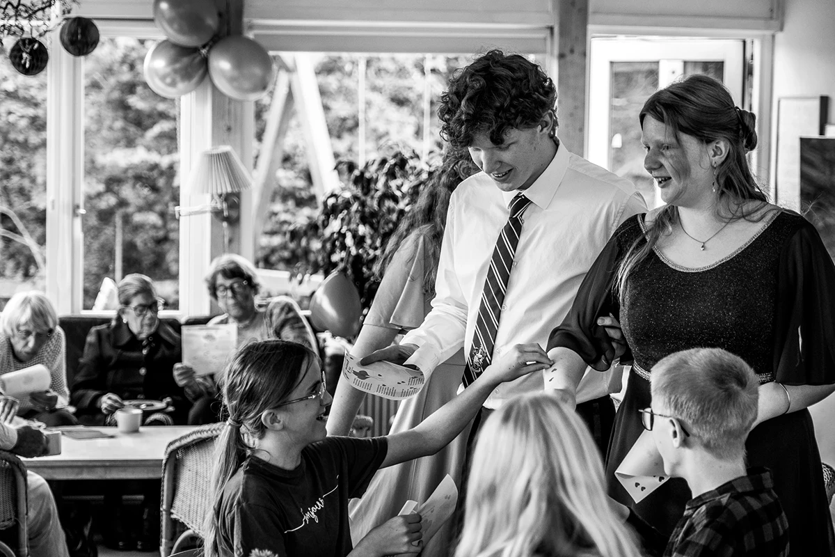 A young girl places a heart sticker on the party girl.