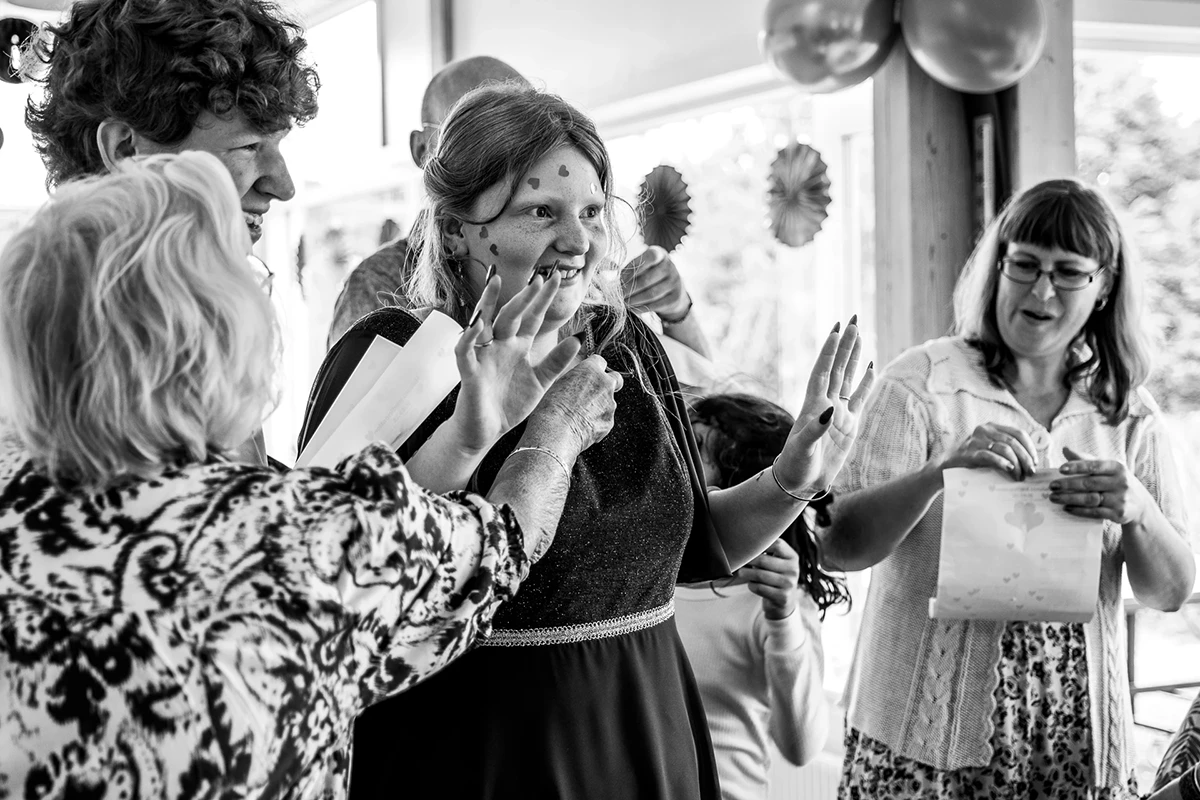 Family and friends place heart stickers on the confirmand