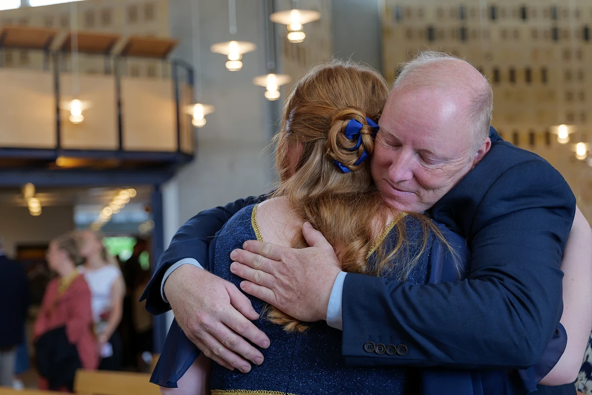 Father embraces her daughter the day of her confirmation.