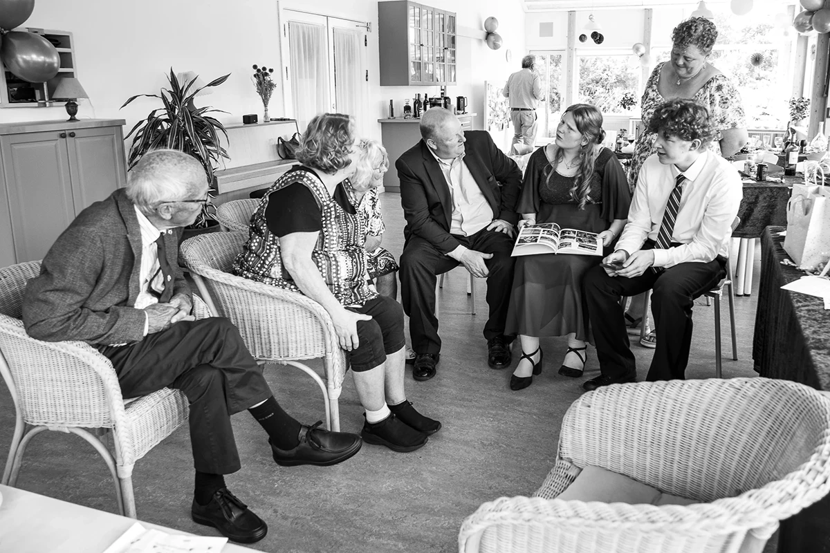 Family gets around the girl party to remember milestones of her childhood.